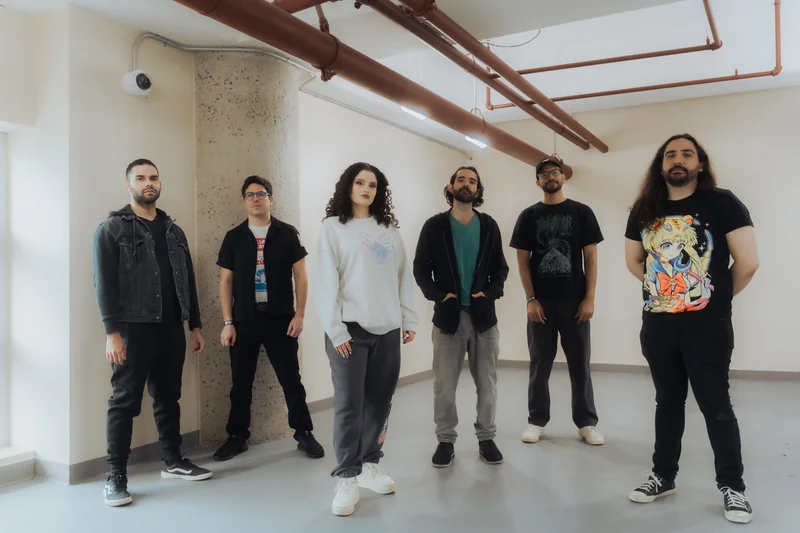 MOTHS band members standing in industrial space with exposed pipes